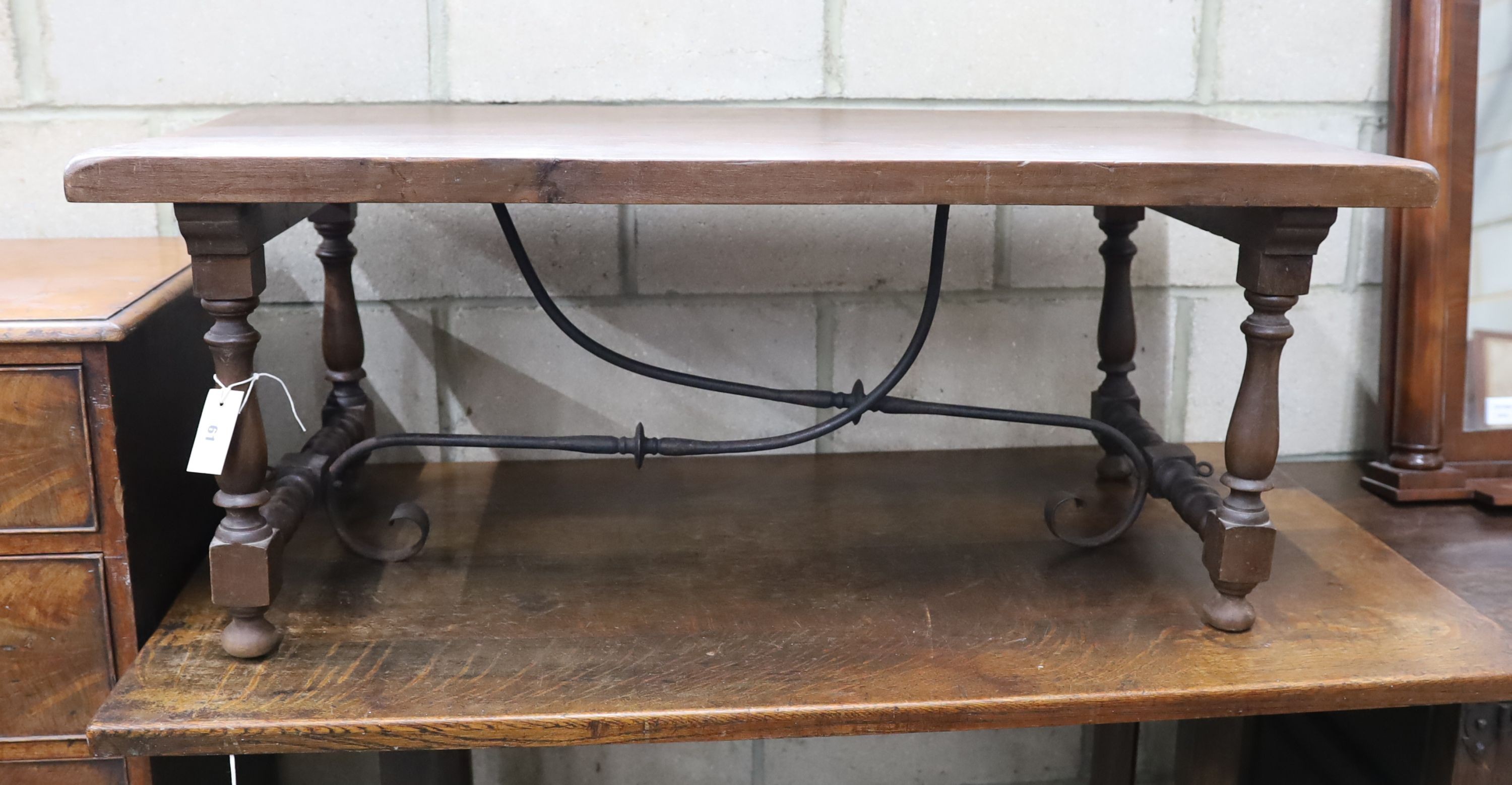 A Spanish style rectangular fruitwood low table, with wrought iron stretcher, length 107cm, depth 57cm, height 43cm